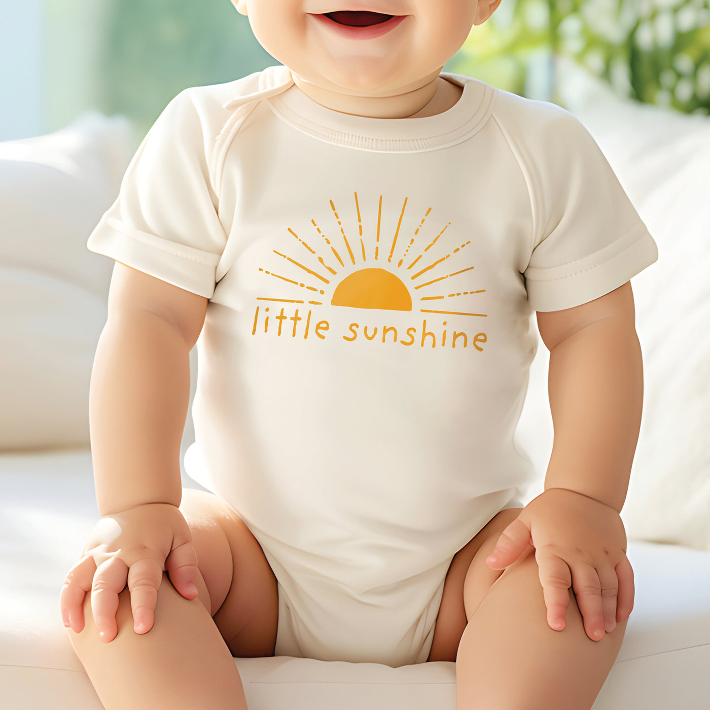 little baby boy wearing natural white onesie with mustard yellow little sunshine with boho sun rays print