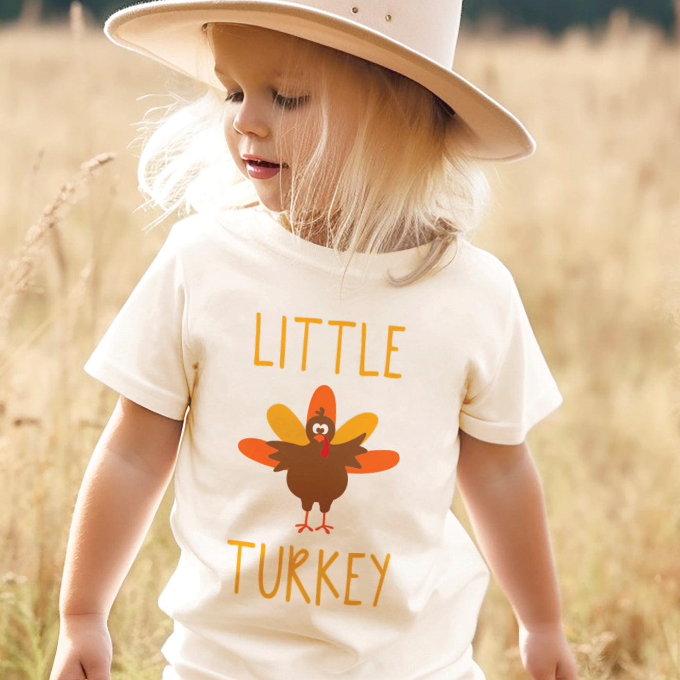 little girl wearing fall hat and natural white tshirt with little turkey print