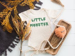 Little monster dripping green text halloween onesie mocked with pumpkin and fall foliage